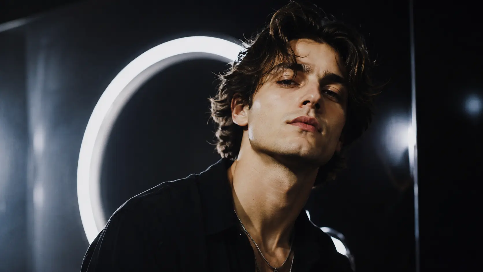 A portrait photographed in front of a ring light before the background is changed.