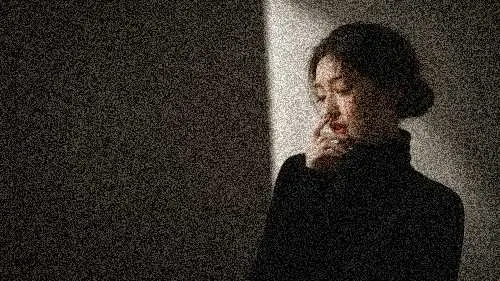 A noisy low-light portrait before AI denoising.