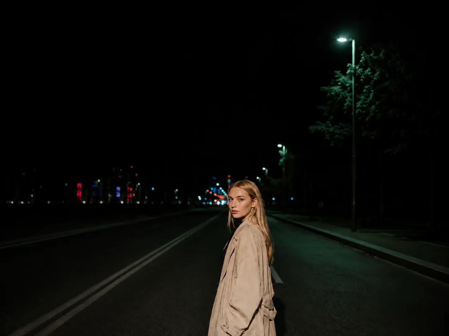 The same low-light street portrait after digital noise has been reduced.