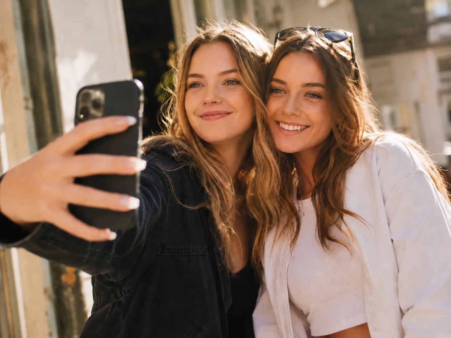 The same two-person selfie with natural-looking open eyes and consistent lighting.
