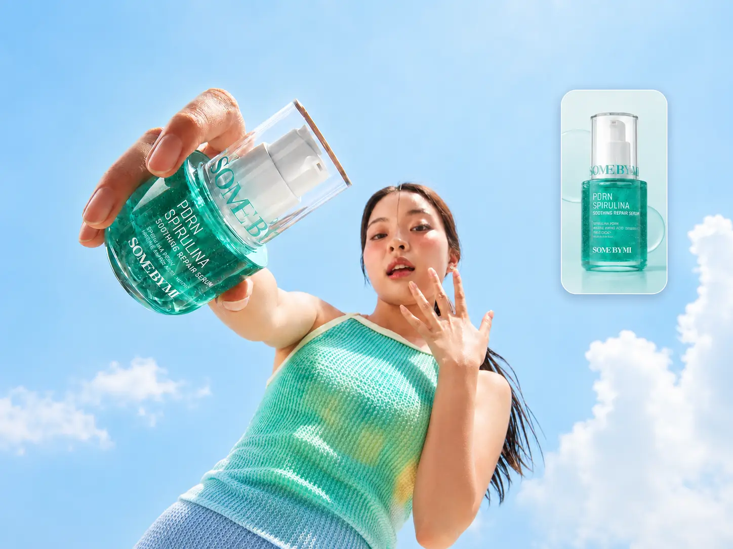 A model holding a green skincare serum against a blue sky in a lifestyle product photo.