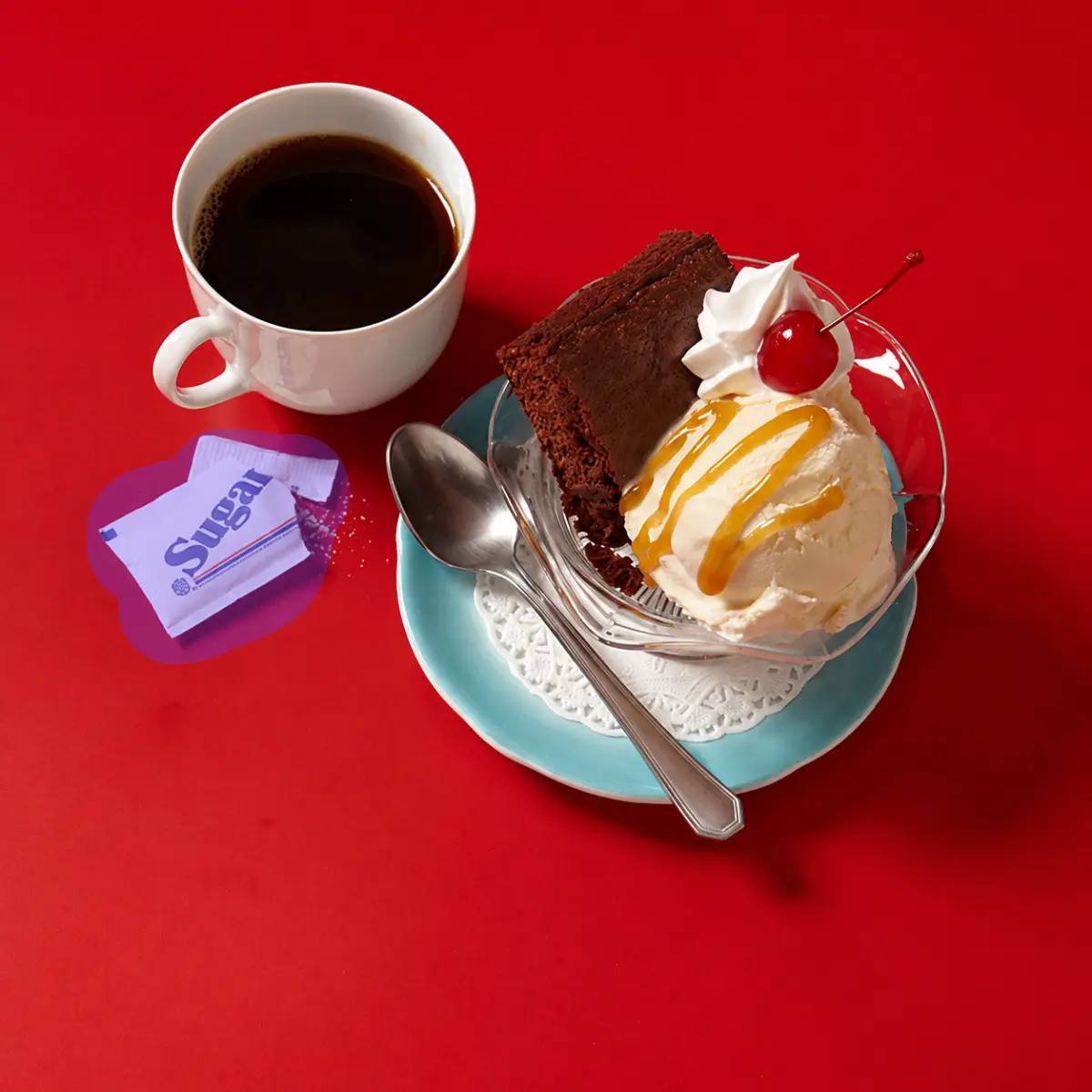 Coffee and dessert with a sugar packet marked for removal