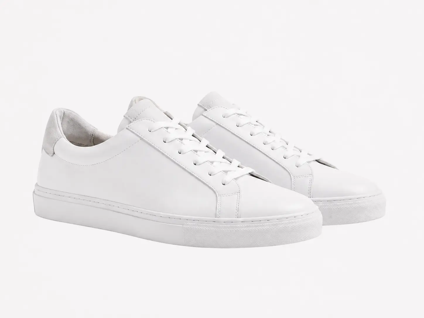 White sneakers on a plain background before a product shadow is added.