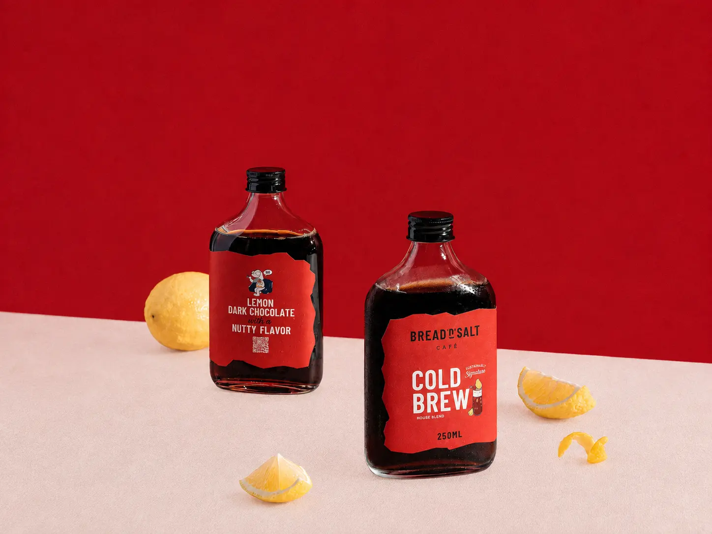 Cold brew bottles and lemons in a red studio scene before shadows are added.