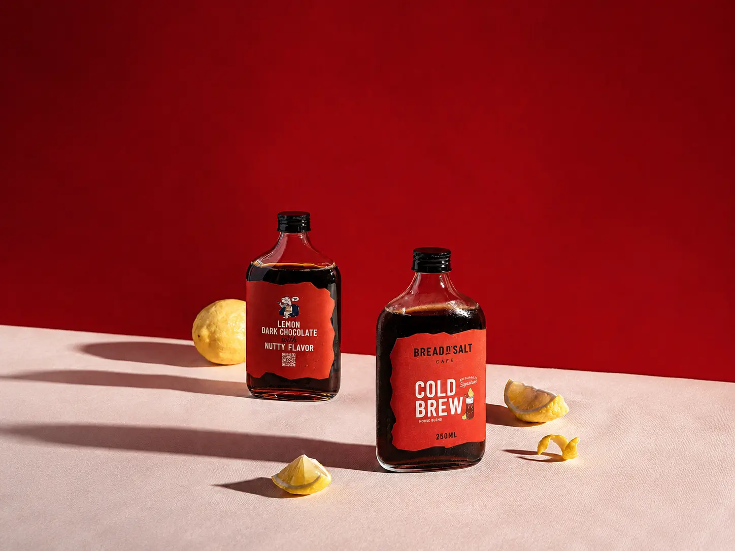 Cold brew bottles and lemons with long directional product shadows.