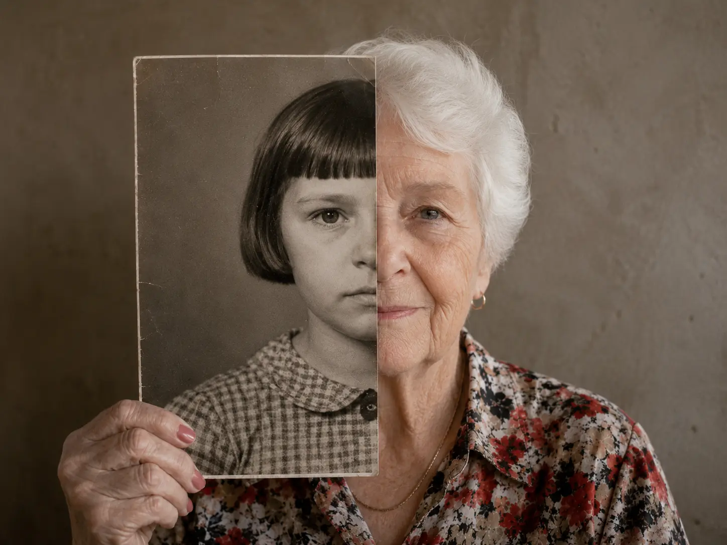 An older woman holding a childhood portrait for a personal memory project.